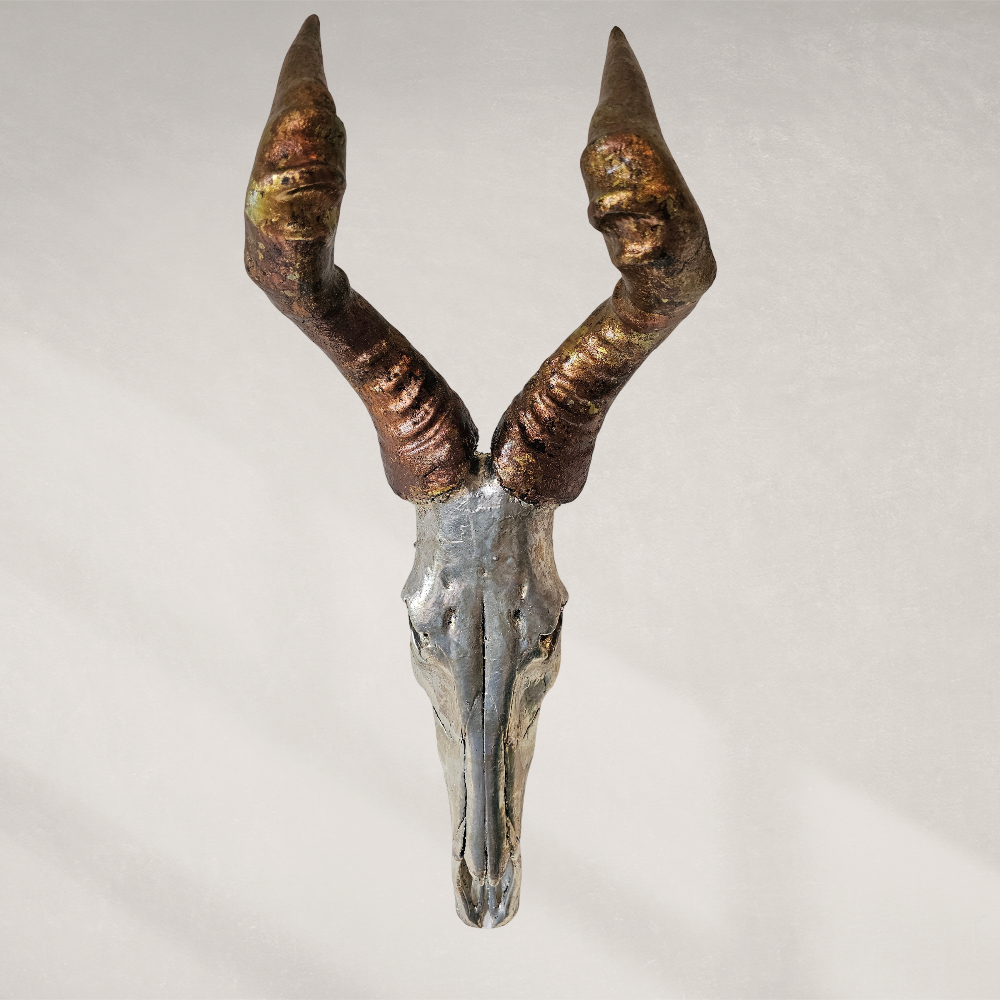 Decorative antelope skull with large horns on a light gray background
